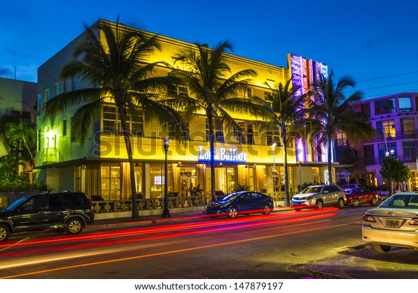 MIAMI BEACH - July 28: Night view at Ocean drive
on July 28, 2013 in Miami Beach, Florida. Art Deco Night-Life in
South Beach at ocean drive  is one of the main tourist attractions
in Miami.