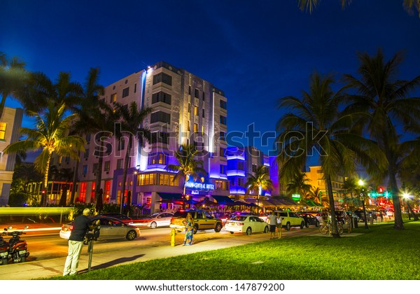 MIAMI BEACH - July 28: Night view at Ocean drive\
on July 28, 2013 in Miami Beach, Florida. Art Deco Night-Life in\
South Beach at ocean drive  is one of the main tourist attractions\
in Miami.