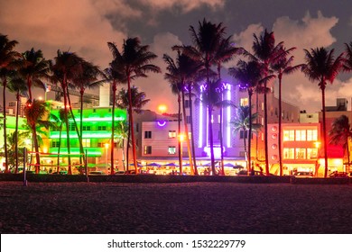 Miami Beach Ocean Drive Hotels And Restaurants At Sunset. City Skyline With Palm Trees At Night. Art Deco Nightlife On South Beach