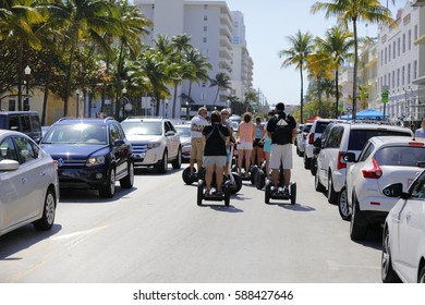 MIAMI BEACH, USA - FEBRUARY 26, 2017: Stock Image Of Tourists Riding Segways On Ocean Drive During The South Beach Wine And Food Festival. 