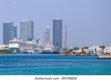 MIAMI BEACH, USA - MAY 9, 2015: Several cruise ships at the Port of Miami with skyscrapers in the back.