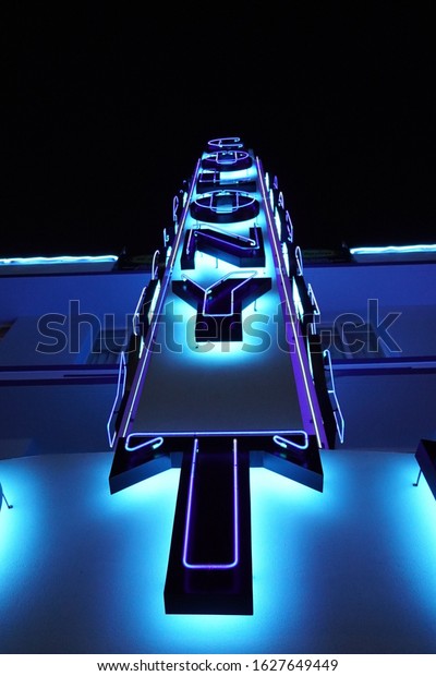 Miami Beach, USA - November 26th, 2020: Ocean\
Drive art deco neon by night. The Colony hotel signage, an iconic\
art deco masterpiece, in closeup\
