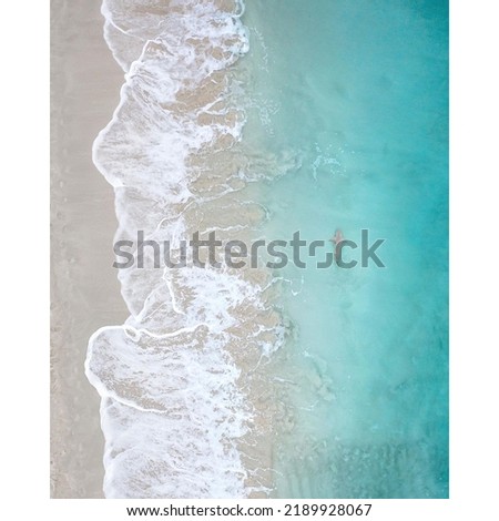 Similar – Luftaufnahme Panoramadrohne Blick auf den blauen Ozean Wellen, die am Sandstrand in Portugal erdrücken.