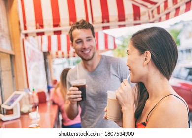 Miami cafe happy couple drinking cold coffee drinks at outdoor terrace of typical retro Florida restaurant. local food. Summer travel tourists. - Powered by Shutterstock