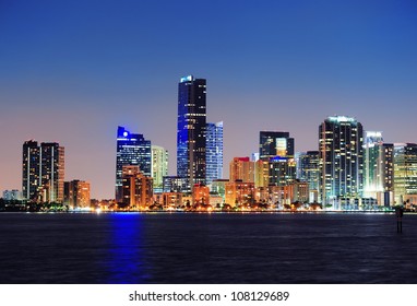 Miami City Skyline Panorama At Dusk With Urban Skyscrapers Over Sea With Reflection