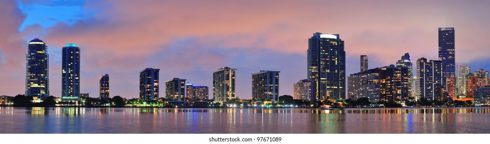 Miami City Skyline Panorama At Dusk With Urban Skyscrapers Over Sea With Reflection