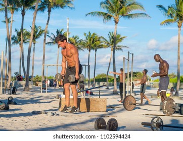 MIAMI - DECEMBER 29, 2017: Muscular Young Men Work Out In The Outdoor Gym Known As Muscle Beach In Lummus Park.