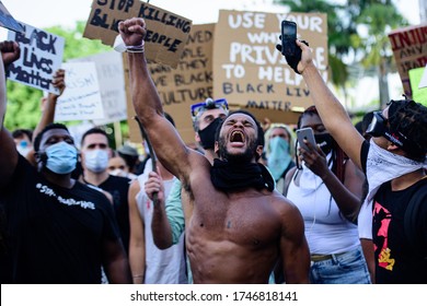 Miami Downtown, FL, USA - MAY 31, 2020: Black Lives Matter. The cry of the soul of a black man. The struggle for the rights of people. George Floyd death: people are protesting and rioting