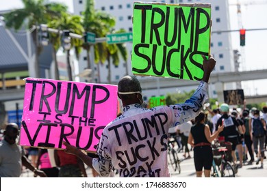 Miami Downtown, FL, USA - MAY 31, 2020: Black man with posters against US President Donald Trump. Trump is the virus it said. Demonstration against racism and politics, elections, vote