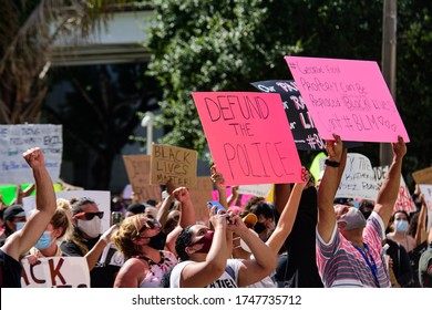 Miami Downtown, FL, USA - MAY 31, 2020: Defund The Police Poster. Black Lives Demonstration. Black Lives Matter. Many American People Went To Peaceful Protests In The US Against The George Floyd Death