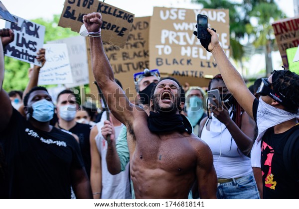 Miami Downtown, FL, USA - MAY 31, 2020: Black\
Lives Matter. The cry of the soul of a black man. The struggle for\
the rights of people. George Floyd death: people are protesting and\
rioting