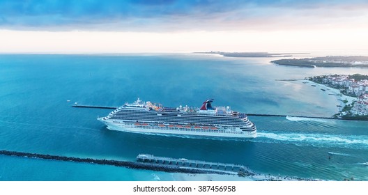 MIAMI - FEBRUARY 27, 2016: Aerial view of Cruise Ship departing from Miami Port. The city is a famous tropical destination for cruises.