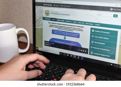 Miami, FL, USA- Feb 22, 2021: Person Living Out Of State Applying For Unemployment Insurance Benefits Using The Hawaii Unemployment Website Under The CARES Act Due To COVID19 Pandemic Pua Peuc Fpuc 