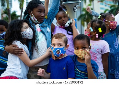 Miami, FL, USA - JUNE 7, 2020: White and black children together. Schoolchildren and teenagers at a demonstration in the USA after the death of George Floyd