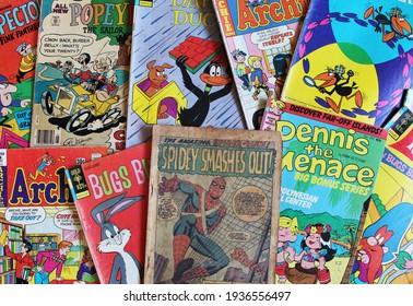 Miami, FL, USA: March 15, 2021: Color Comics Adverts On A Table. Stack Of Old Vintage Comic Books Background.