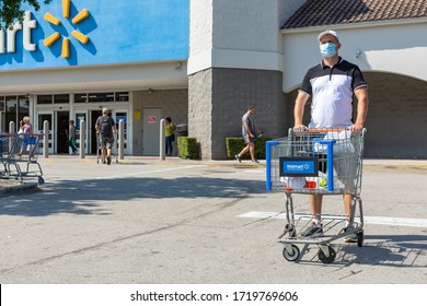 Miami, FL, USA - March 26, 2020:Man wearing medical mask on Walmart store parking space. Walmart is the world's third largest public corporation. Quarantine due Coronavirus time. 