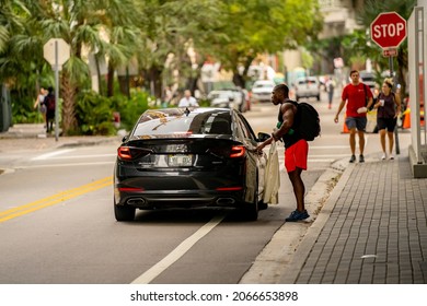 Miami, FL, USA - October 30, 2021: Photo Of A Young Man Taking An Uber Lyft Without His Face Mask While Apps Require Masks To Be Worn At All Times