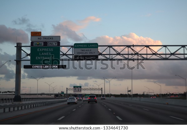 MIAMI, FLORIDA -8 MARCH 2019- View of a tollbooth on\
the road at the entrance. Sunpass holders go through an express\
lane