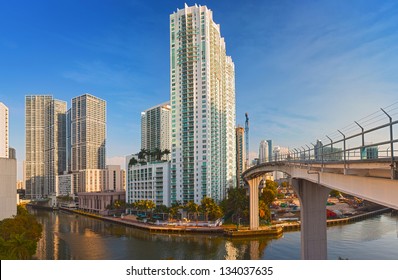Miami Florida, Brickell and downtown financial buildings and train bridge over miami River on a beautiful summer day with blue sky