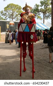 MIAMI, FLORIDA - MARCH 12, 2016: Knights battle at Renaissance Fair in authentic costumes, Renfair, Clown jester joker petrushka