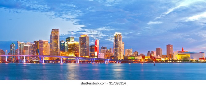 Miami Florida at sunset, cityscape of modern downtown buildings illuminated with reflections in the waters of Biscayne BAy