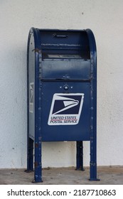 MIAMI, FLORIDA USA - 08-05-2022
United States Postal Service (USPS) Collection Box Isolated Against Light Neutral Background.