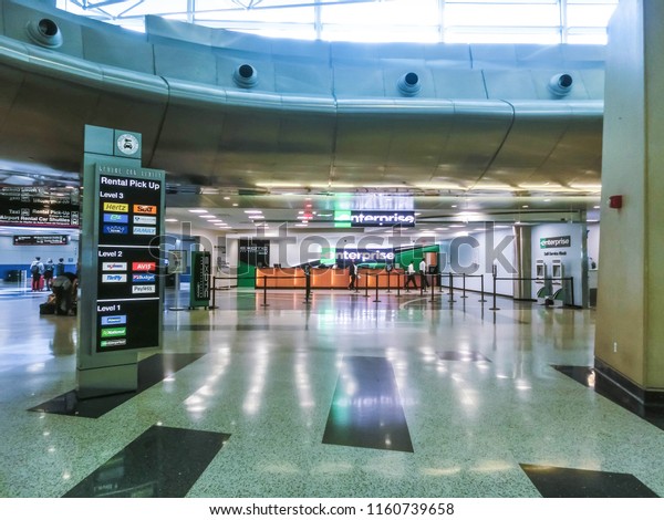 Miami, Florida, USA - Aprile 28, 2018: The people\
near Enterprice rental car office at Miami airport at Miami,\
Florida, USA on Aprile 28,\
2018