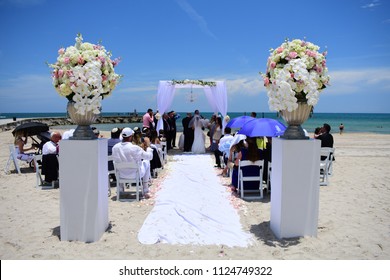 Miami, Florida / USA - June 24 2018: A Jewish beach wedding in a sunny, hot, and humid day in Miami