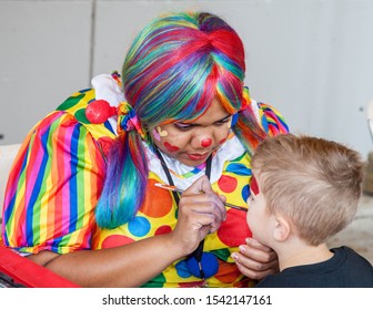 Miami, Florida . USA - November 22, 2014: Artist Doing Clown Makeup For A Little Boy