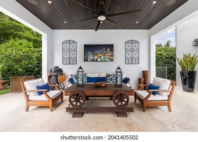 Miami, Florida, USA. September 3, 2021: Outdoor Living Room With Roof, Chairs, Grill, Television, Fan And A Background Of Trees.