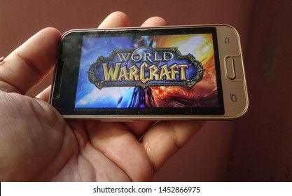 Miami, Florida/USA - May 3, 2019: A hand holding a smartphone with the electronic game image of World of Warcraft.