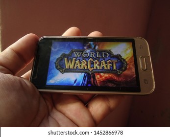 Miami, Florida/USA - May 3, 2019: A hand holding a smartphone with the electronic game image of World of Warcraft.