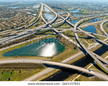 Miami freeway interchange with elevated road lanes for fast express driving of cars. Vehicles driving on huge complex expressway junction