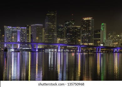Miami skyline by night with illuminated  port bridge
