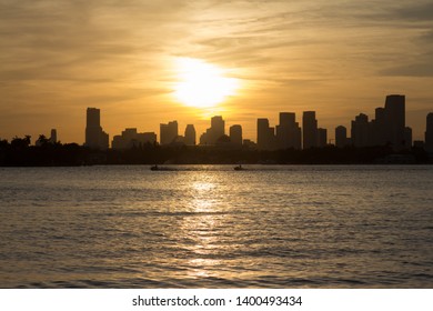 Miami Skyline At Sunset With Jetski Drivers In The Front.