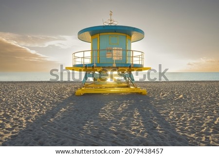 Miami South Beach lifeguard house in a colorful art deco style on a sunny summer morning with the Caribbean Sea in the background. Vacation and travel concept. Florida, USA.