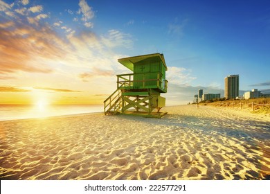 Miami South Beach sunrise with lifeguard tower and coastline with colorful cloud and blue sky.  - Powered by Shutterstock