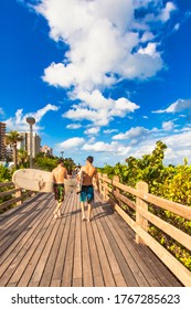 Miami, United States - October 06 2011 :two Surfers With Surf Boards Walk Bare Feet On The Board Walk Next To The Beach