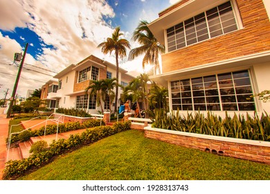Miami, United States - October 06 2011 : an art deco style 60s apartment complex with palm trees and patio