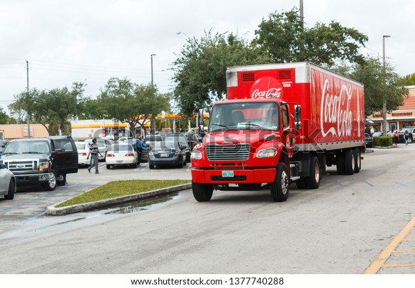MIAMI, USA - April 21, 2019: Coca Cola\
Truck on the street. Coca-Cola is a carbonated soft drink, produced\
by The Coca-Cola Company of Atlanta,\
Georgia.