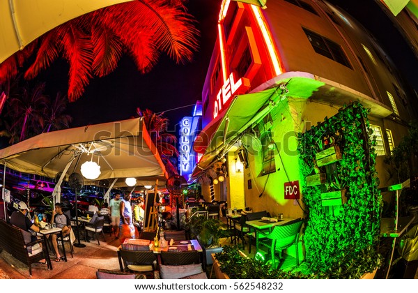 MIAMI, USA - AUG 19, 2014: people enjoy the bar\
and restaurant at night at Ocean drive  in South beach, Miami in\
the art deco district.