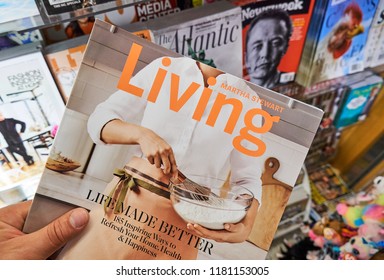 MIAMI, USA - AUGUST 22, 2018: Martha Stewart Living Magazine In A Hand Over A Stack Of Magazines.