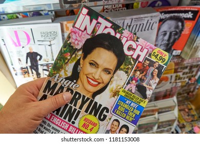 MIAMI, USA - AUGUST 22, 2018: In Touch Magazine In A Hand Over A Stack Of Magazines. In Touch Is An American Popular Weekly Celebrity Gossip Magazine