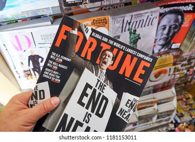 MIAMI, USA - AUGUST 22, 2018: Fortune Magazine In A Hand Over A Stack Of Magazines. Fortune Is A Popular American Multinational Business Magazine Headquartered In New York City