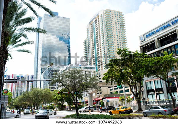 Miami, USA\
- October 30, 2015: financial center with high buildings cars and\
palm trees in business district. Commercial property or real\
estate. Economy and entrepreneurship\
concept.