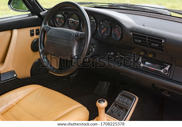 Miami, Year 2019: Classic Porsche 911\
interior. Steering wheel, dash, commands, gear lever. Beige\
Leather, and   black\
components.