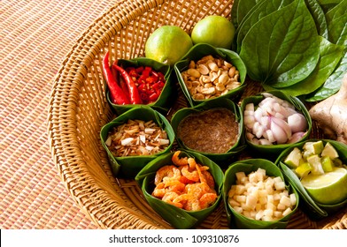 Miang Kham is a tasty snack often sold as Thailand street food. It involves wrapping little tidbits of several items in a leaf, along with a sweet-and-salty sauce.