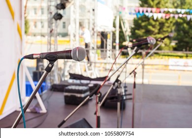 Mic on stage. Microphone on stage against a background of empty concert scene.