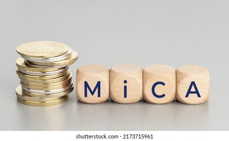 MiCA Or Markets In Crypto Assets Concept. Stacked Cryptocurrency Coins And Wooden Blocks With Text. Copy Space