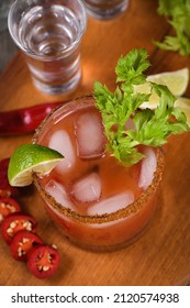 Michelada the Mexican Bloody Mary. Made with tequila, spicy sauce, served over ice in a glass of celery with a peppery rim, garnished with a stalk of celery and a wedge of lime.  